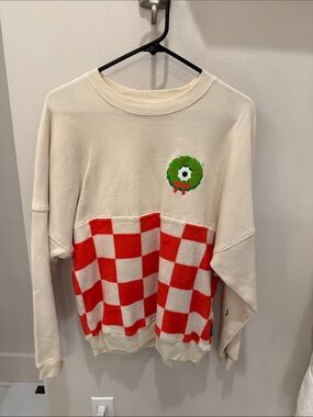 Disney Cream Sweatshirt with Red Checker Panels and Festive Wreath